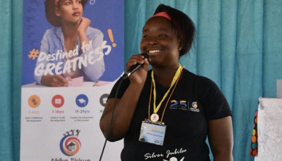 A lady speaking into a microphone.