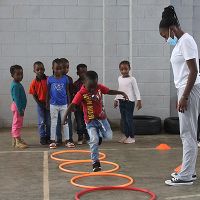 A teacher playing a game with children.