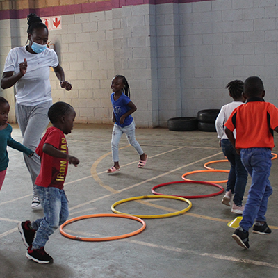 A teacher playing a game with children.